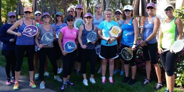 Womens group with paddles raised