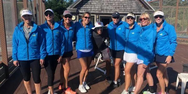 Campers in blue camp jackets on court