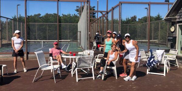 Campers relaxing courtside between sessions