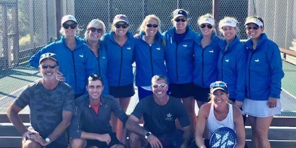 Full group in matching blue camp jackets with coaches
