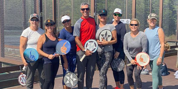Session group with paddles on court