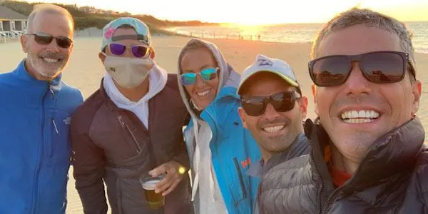 Coaches group selfie at sunset on the beach