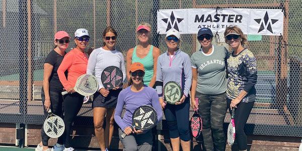 Womens group with Master Athletics banner