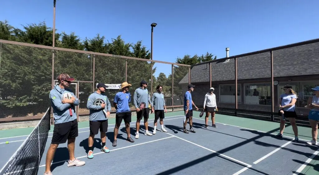 Coaching team lined up on court