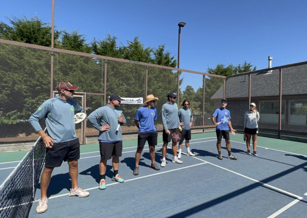 Coaching staff on court during session