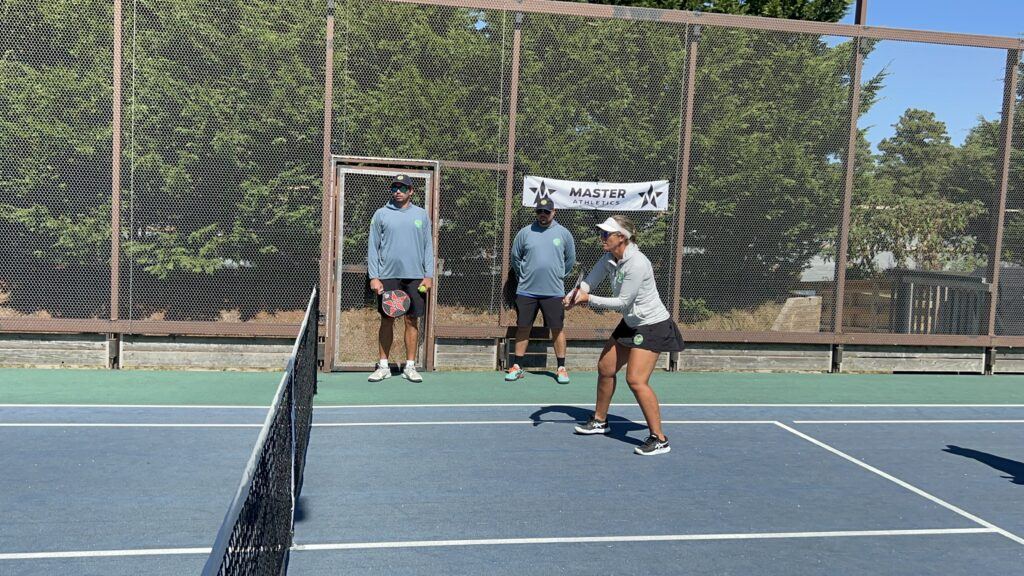 On-court coaching drill with Master Athletics banner