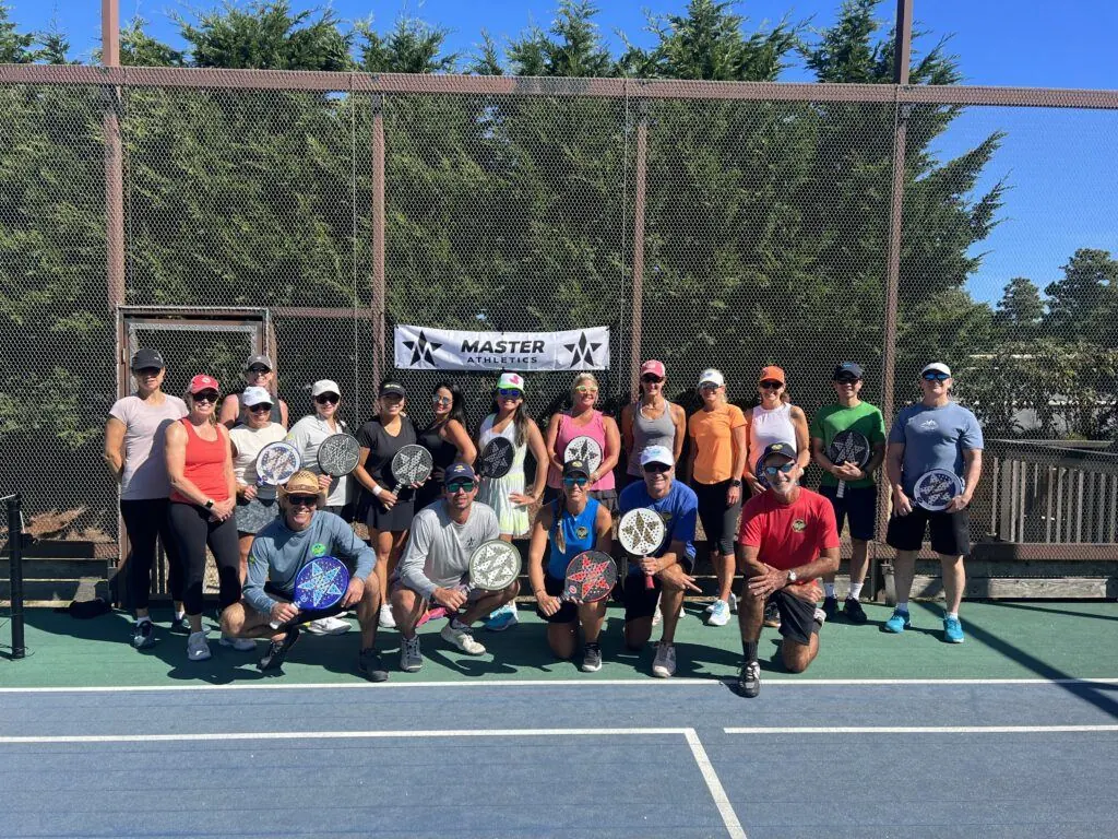 Session group in front of Master Athletics banner
