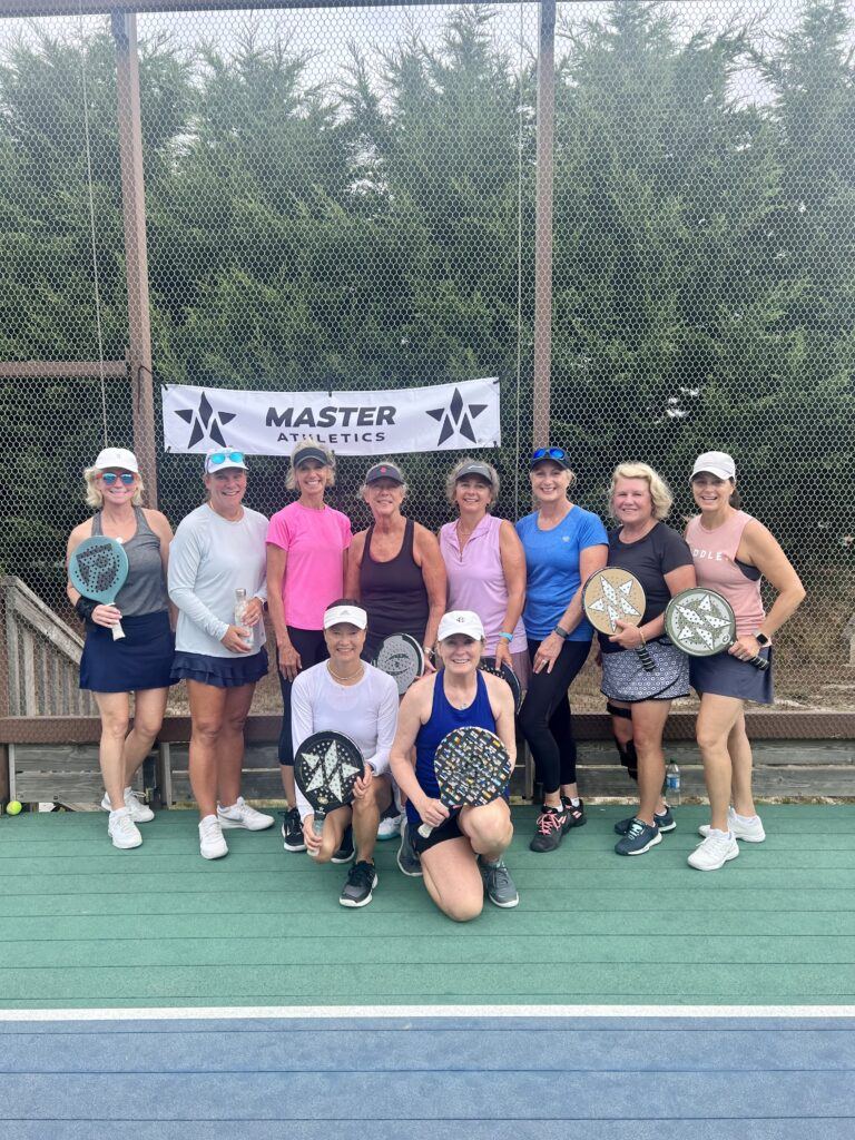 Womens group with Master Athletics banner