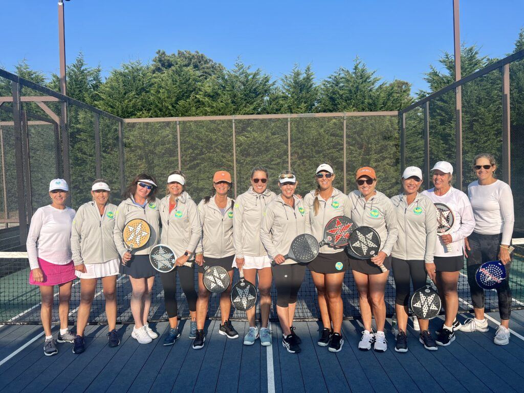 Womens group with paddles on court