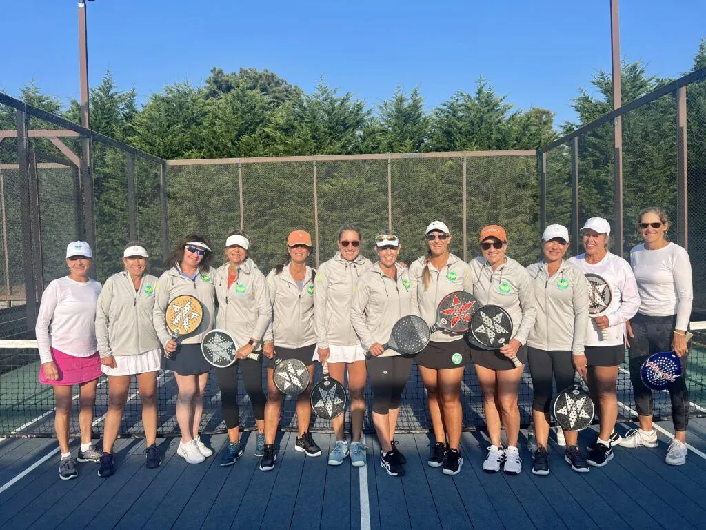 Womens group with paddles on court