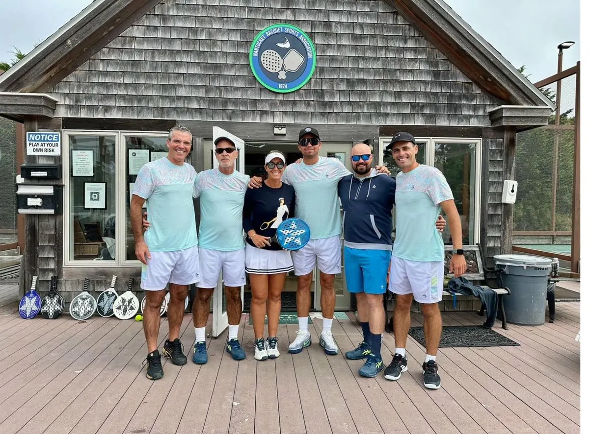 Coaching staff group at NRSA clubhouse entrance